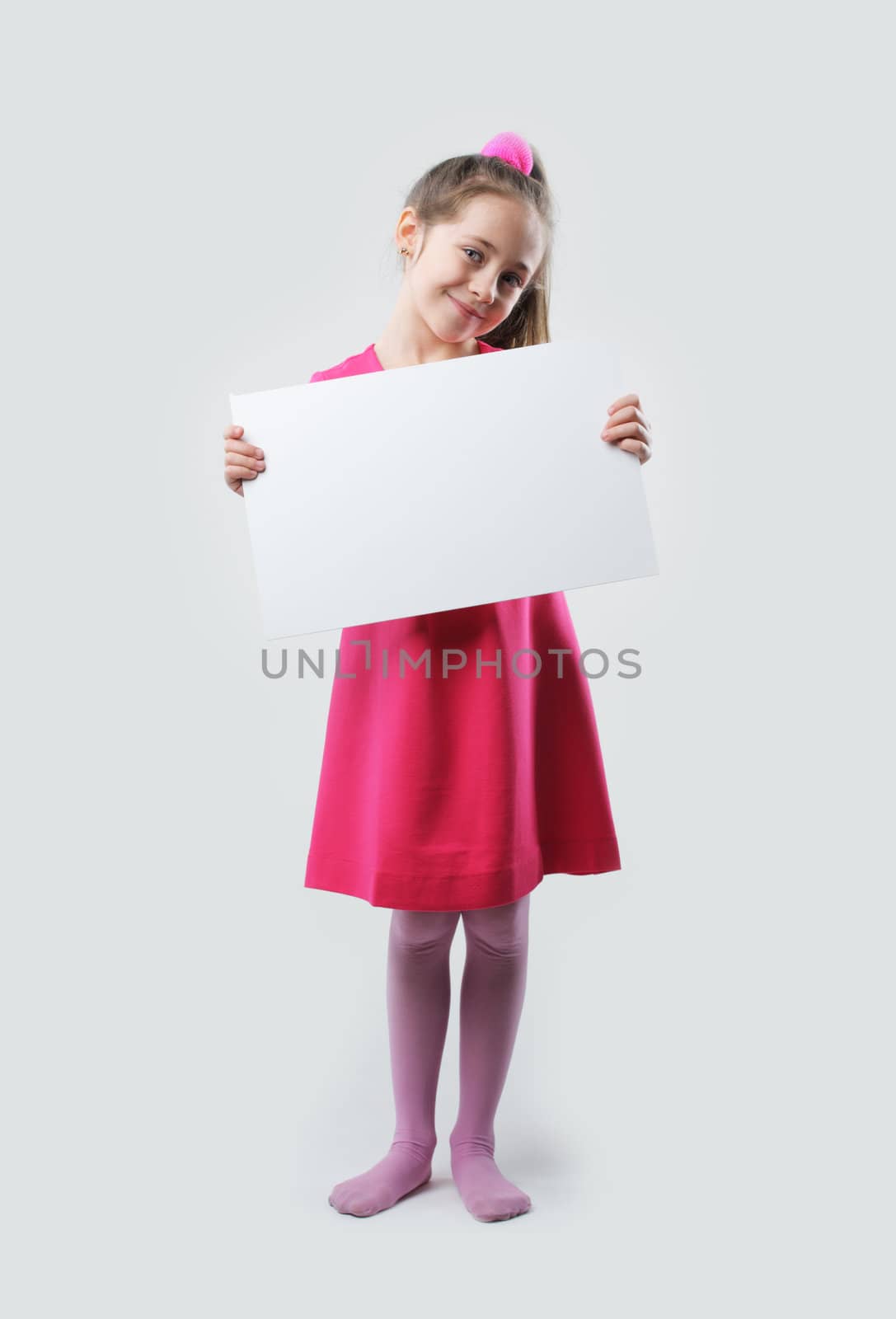 A little girl holds a blank sign, ready for your text