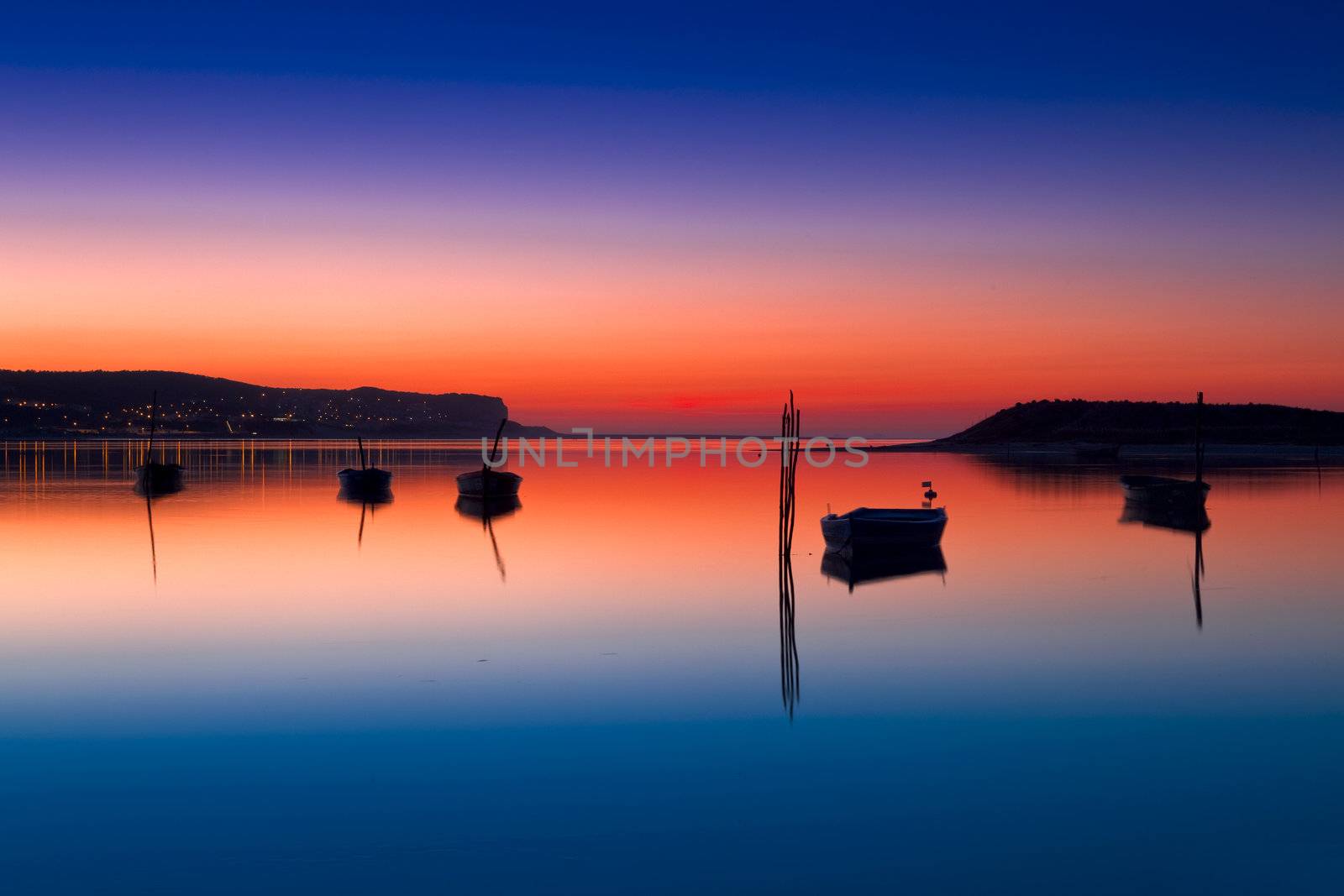 Beautiful landscape of a river and boats at sunset