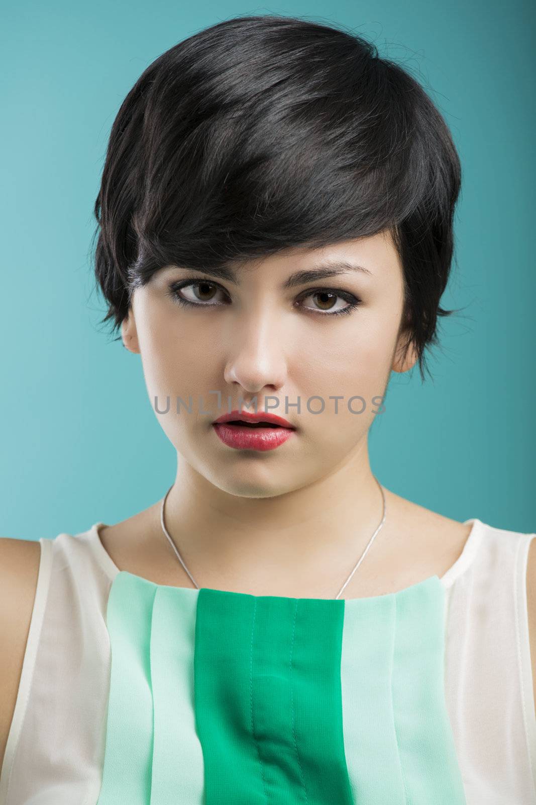 Portrait of a beautiful and fashion woman aganist a blue background