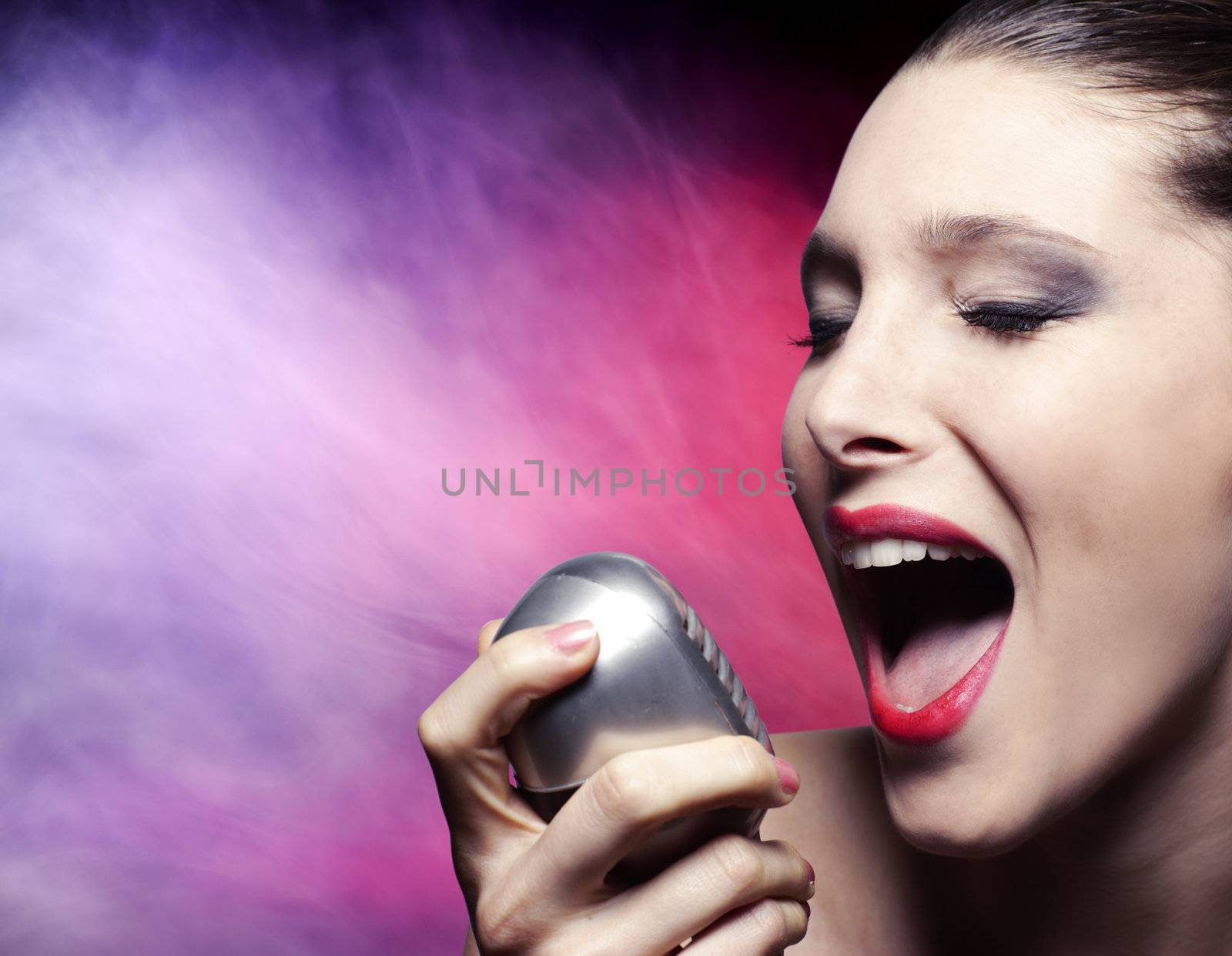 Beautiful female singer with vintage microphone