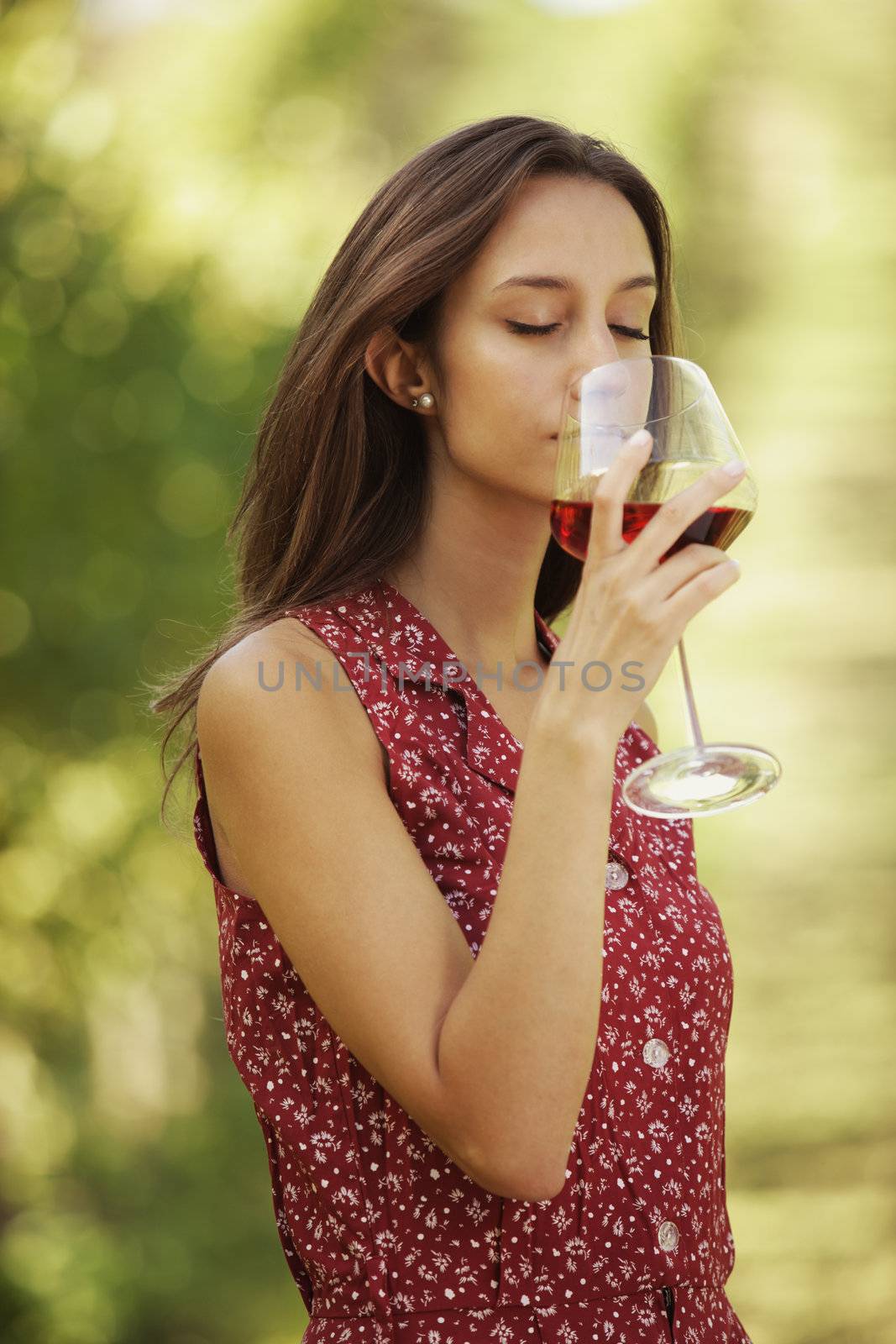 Vintner woman check red wine in a vineyard