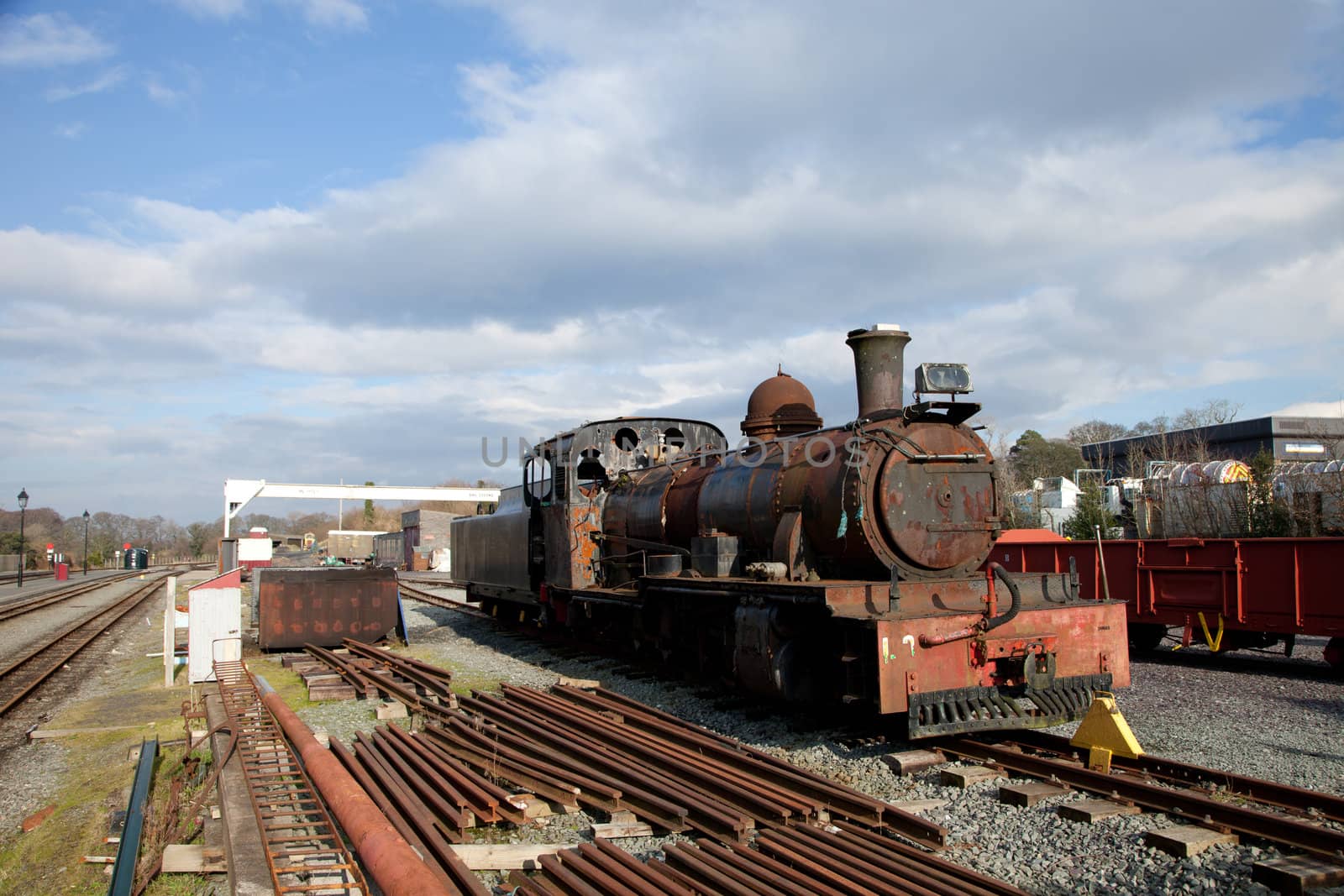 An old vintage reclaimed steam powered locomotive in a railway yard.