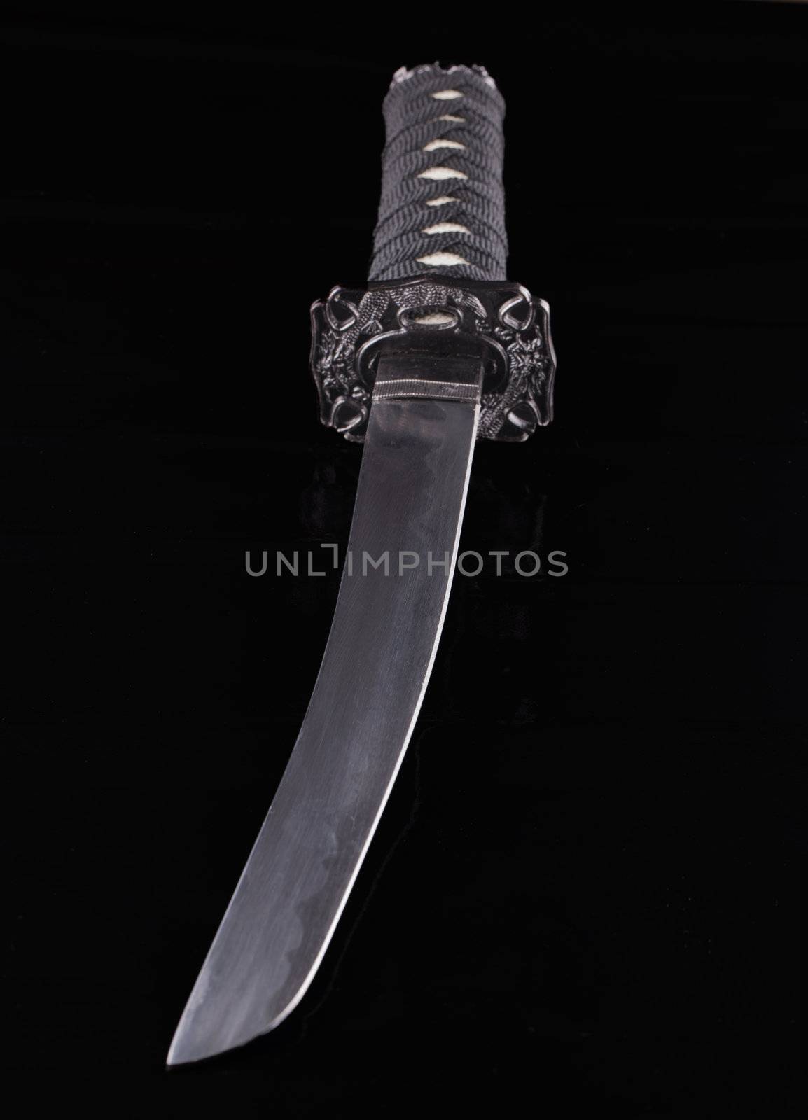 Close up of a katana over a black background