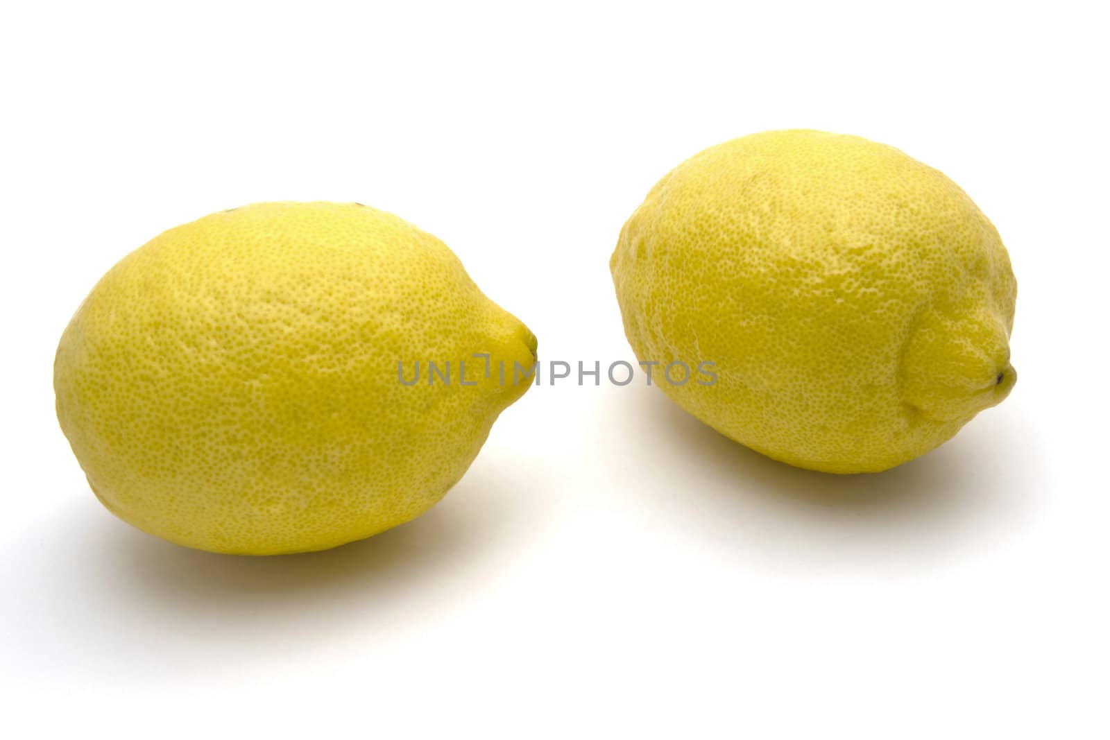 Two Fresh lemons closeup on white background