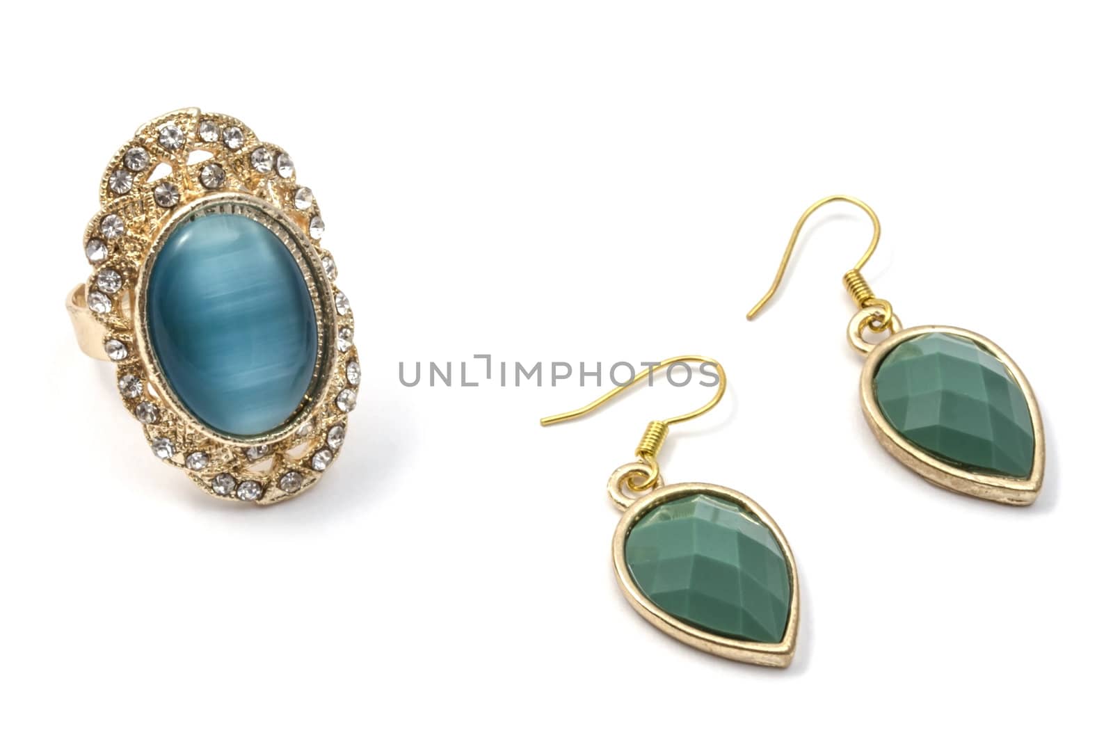 Beautiful earrings and ring  isolated on white background