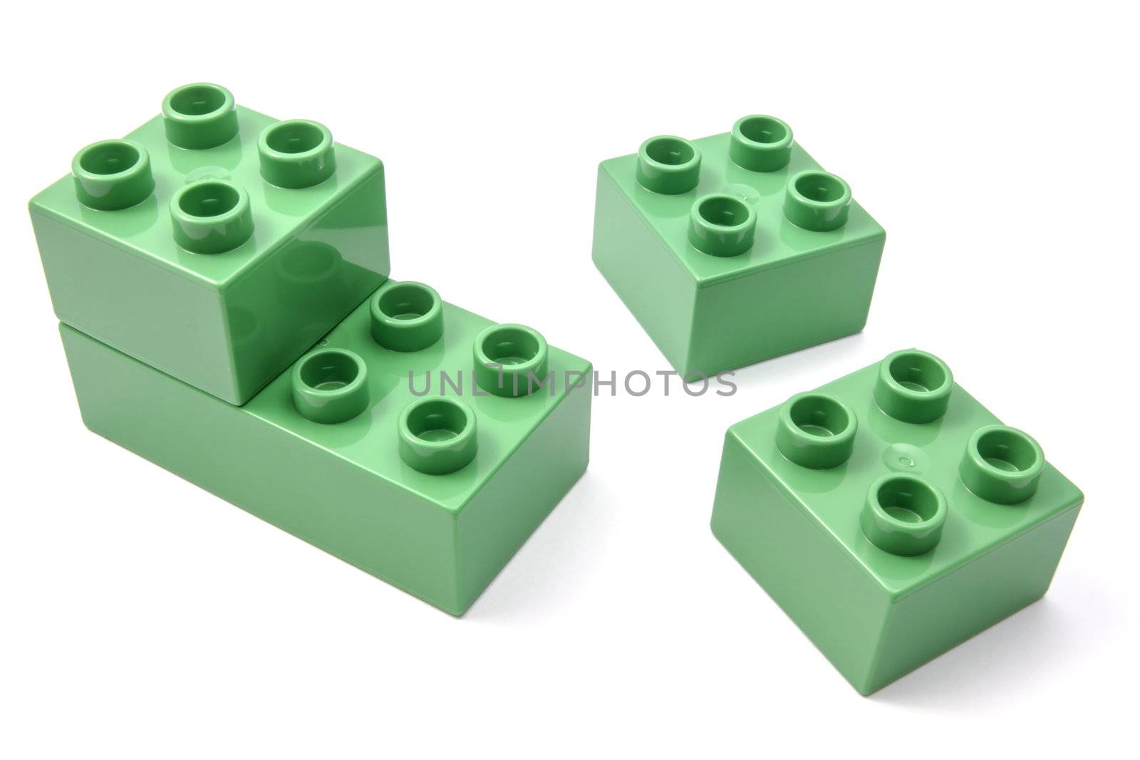 Green building blocks closeup on white background 