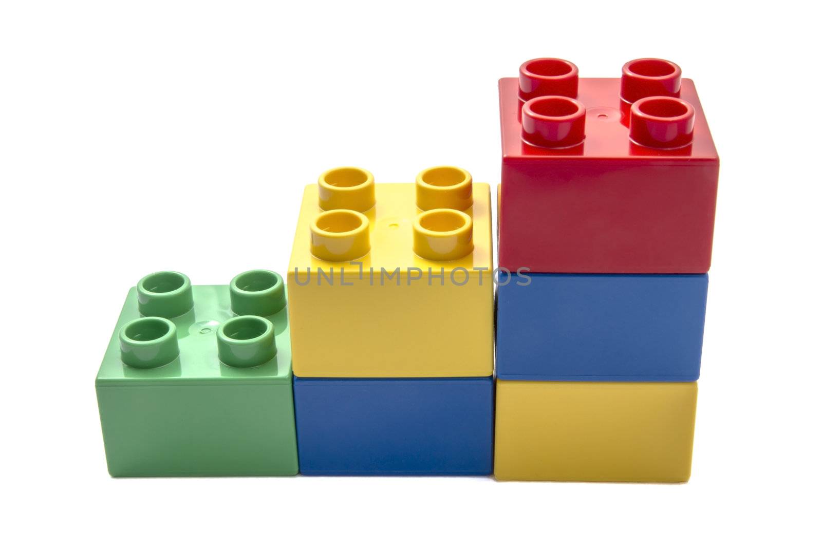 Colorful building blocks closeup on white background 