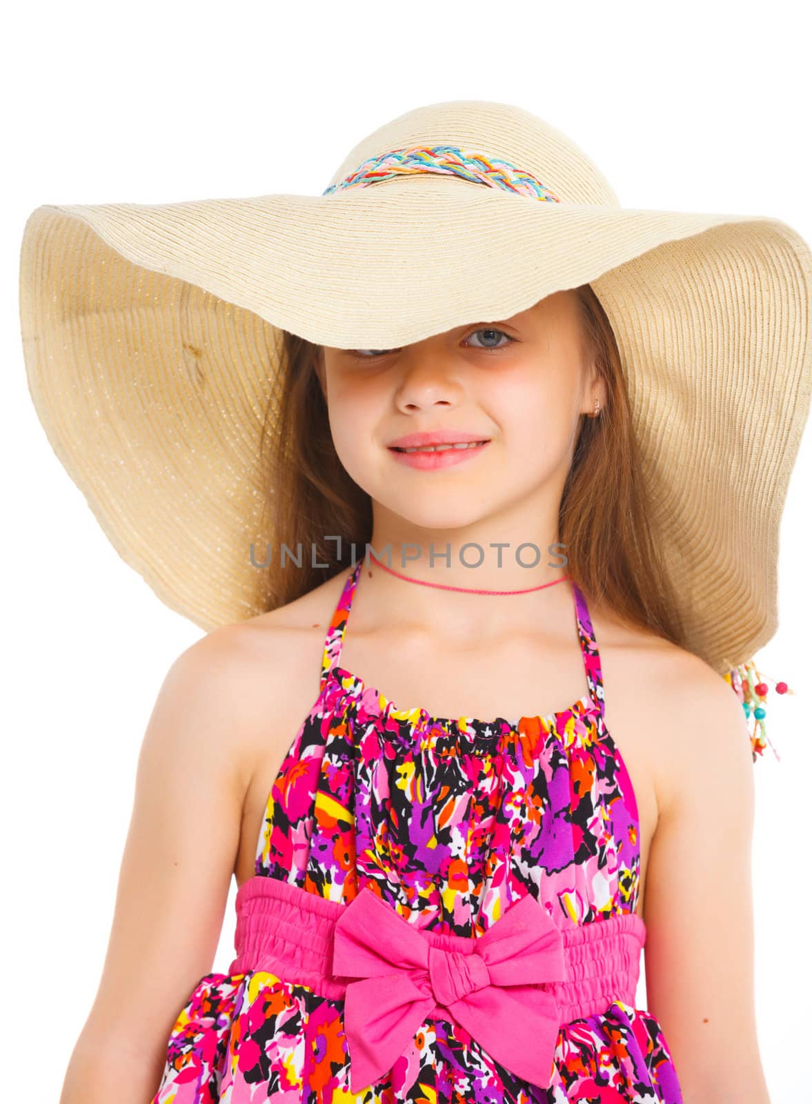 Fashion cute girl in a big hat in the studio