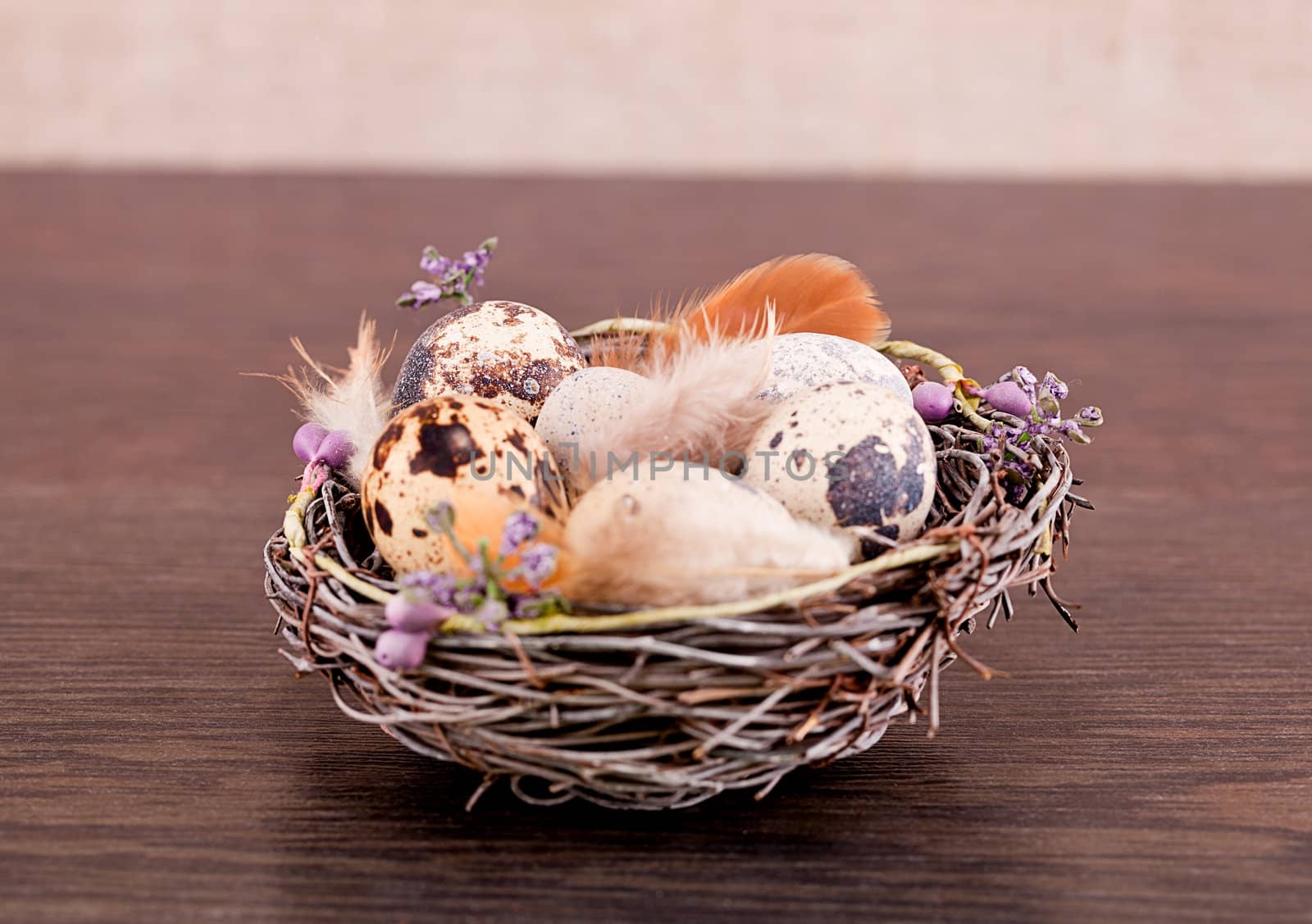 easter decoration with quail eggs on wooden background
