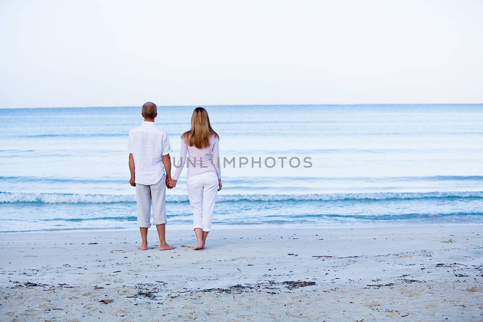 happy young couple in love having fun on the beach blue sky and sunshine 