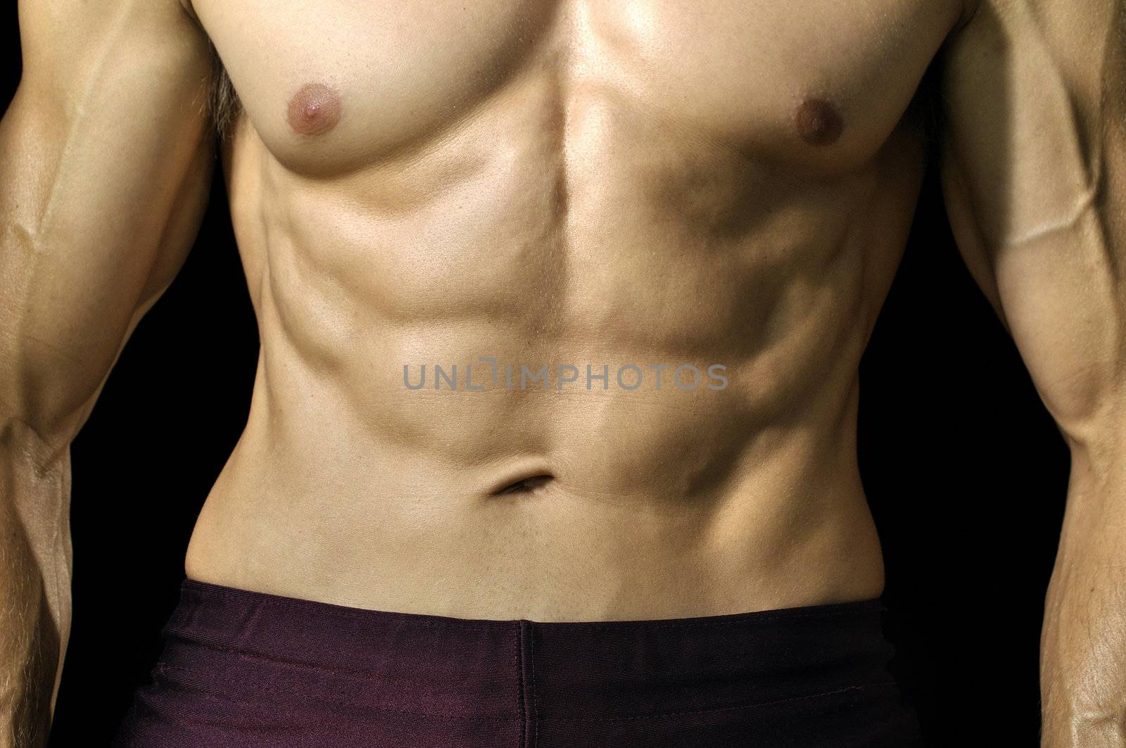 Closeup of muscular abs and torso of male athlete