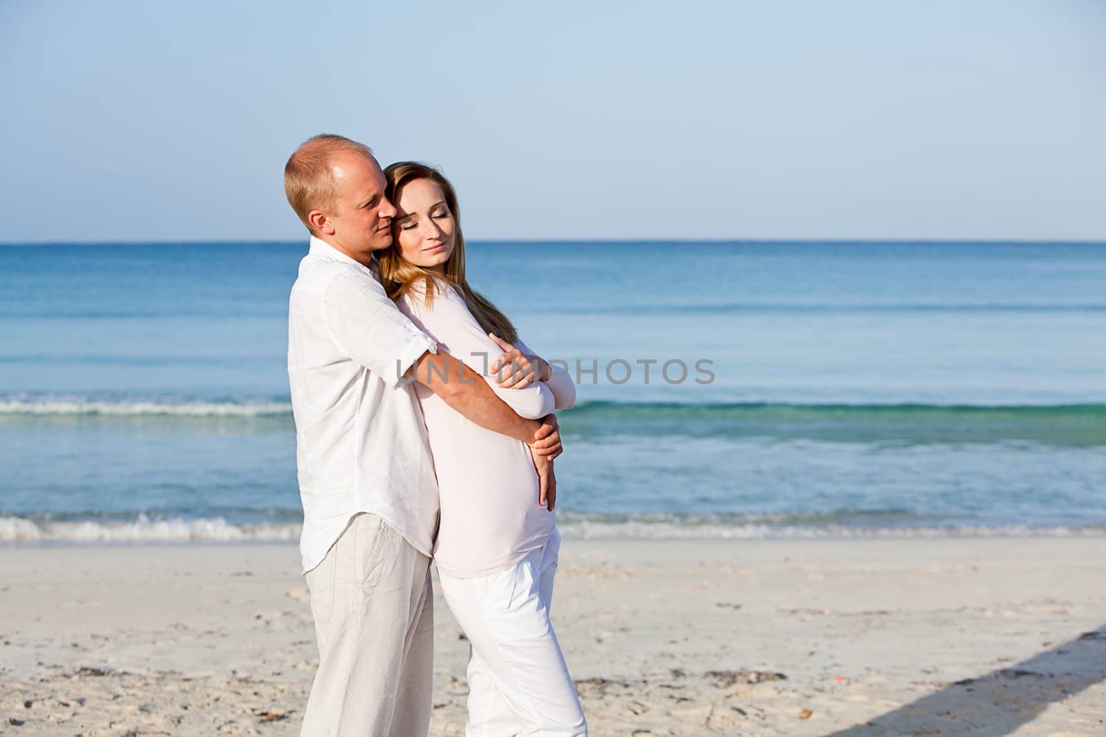 happy young couple in love having fun on the beach blue sky and sunshine 