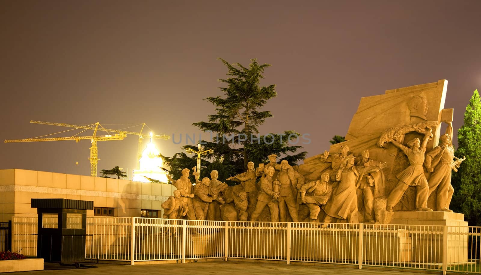 Mao Statue in front Mao Zedong Tse Tung Tomb Tiananmen Square Beijing, China Night Shot  Yellow Building Crane in Background