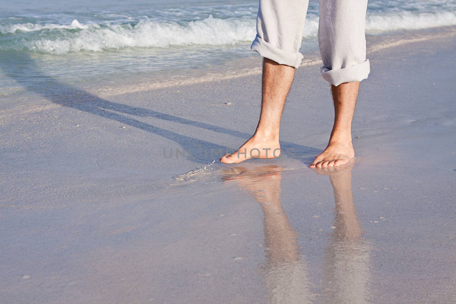walking barefoot in the sand in summer holidays on beach