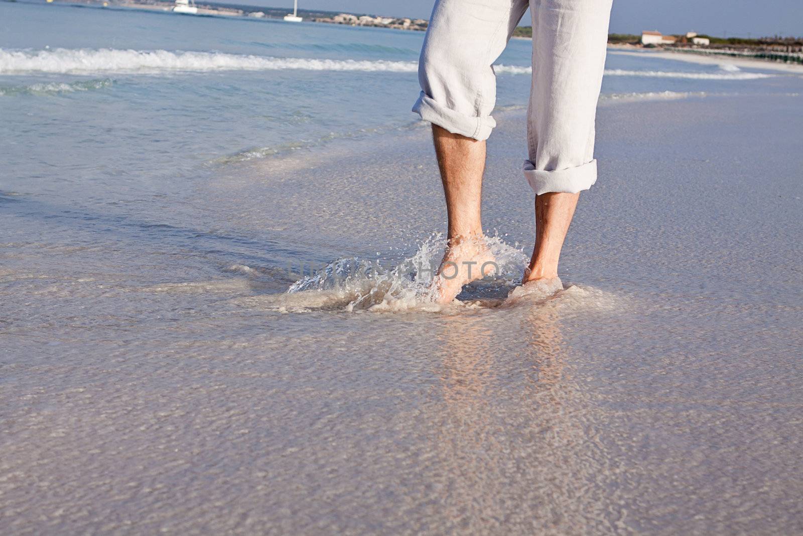walking barefoot in the sand in summer holidays on beach