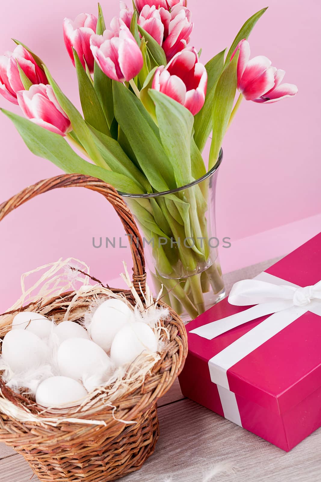 pink present with ribbon and colorful tulips festive easter decoration