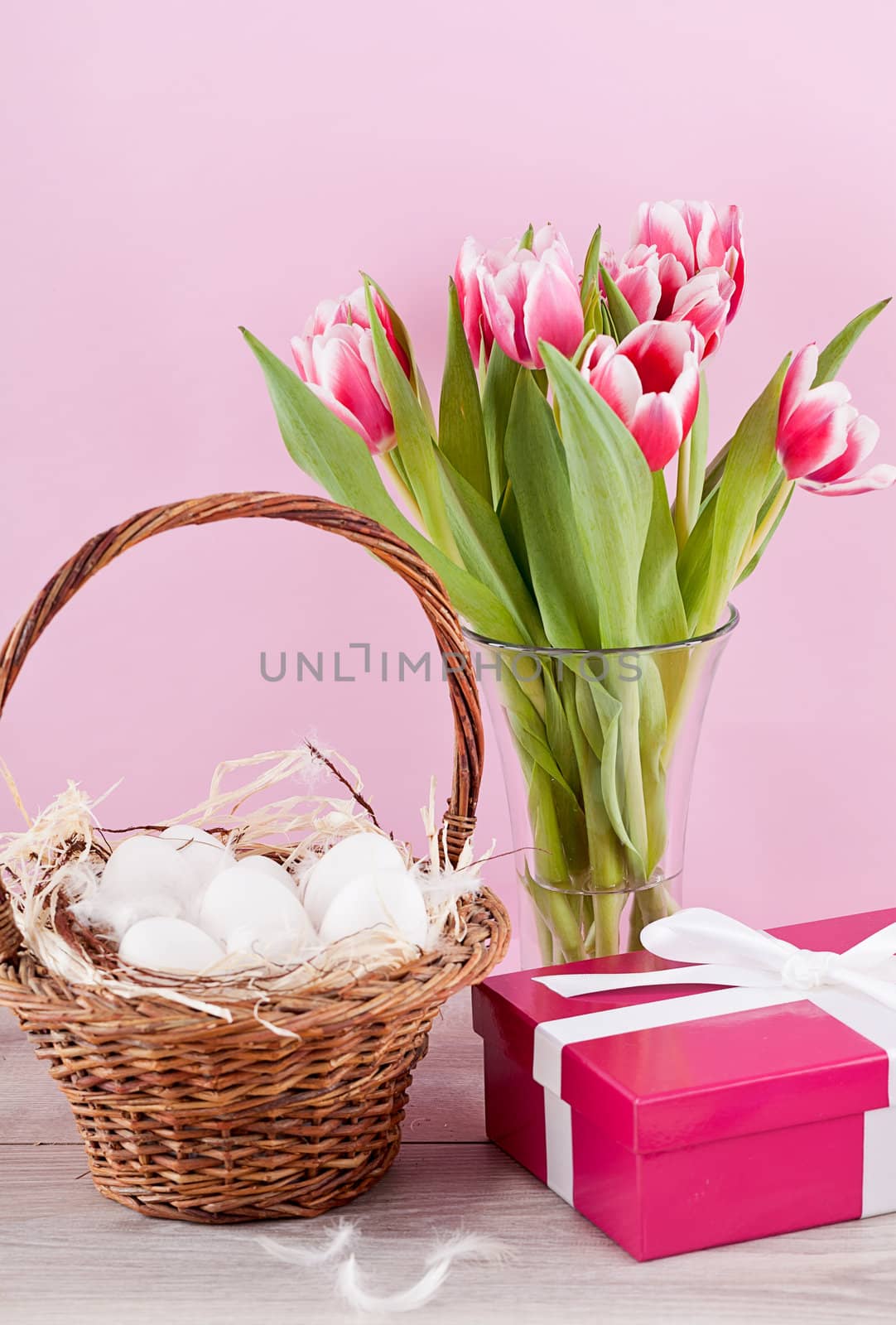 pink present with ribbon and colorful tulips festive easter decoration