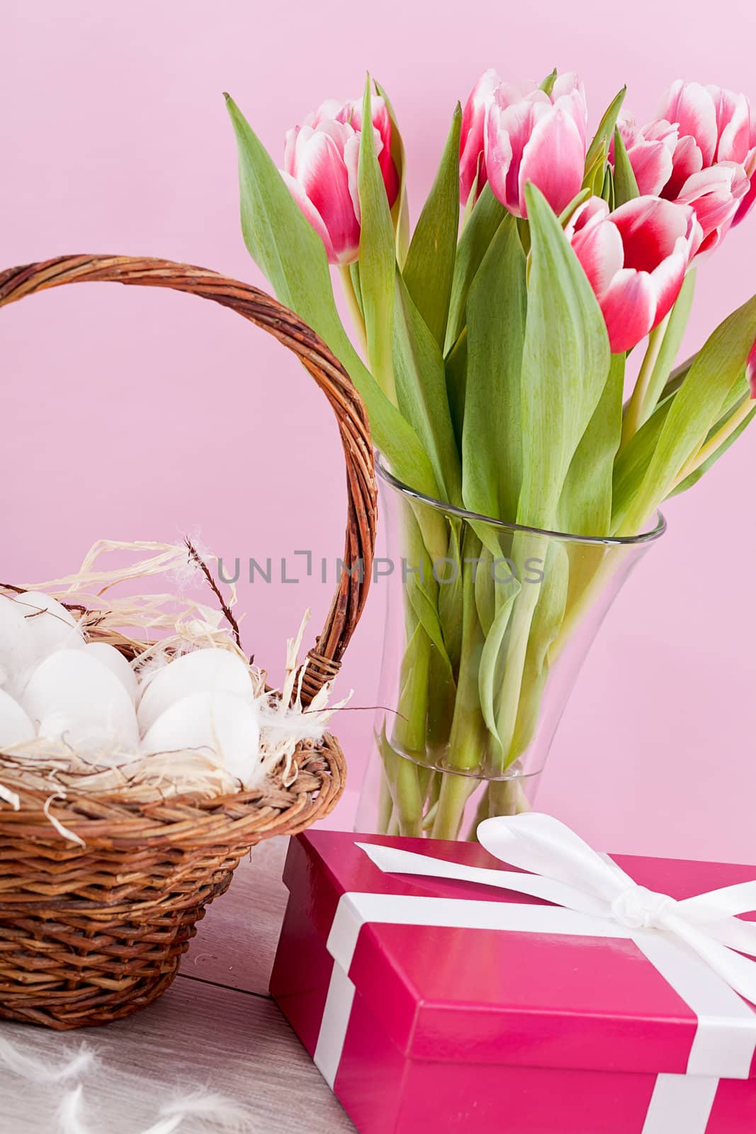 pink present with ribbon and colorful tulips festive easter decoration