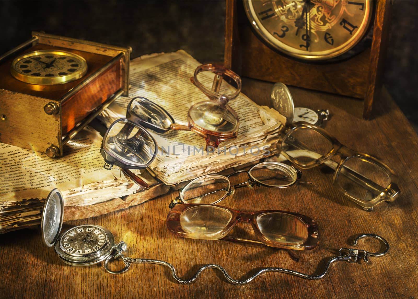 many Glasses and watch lying on a wooden table
