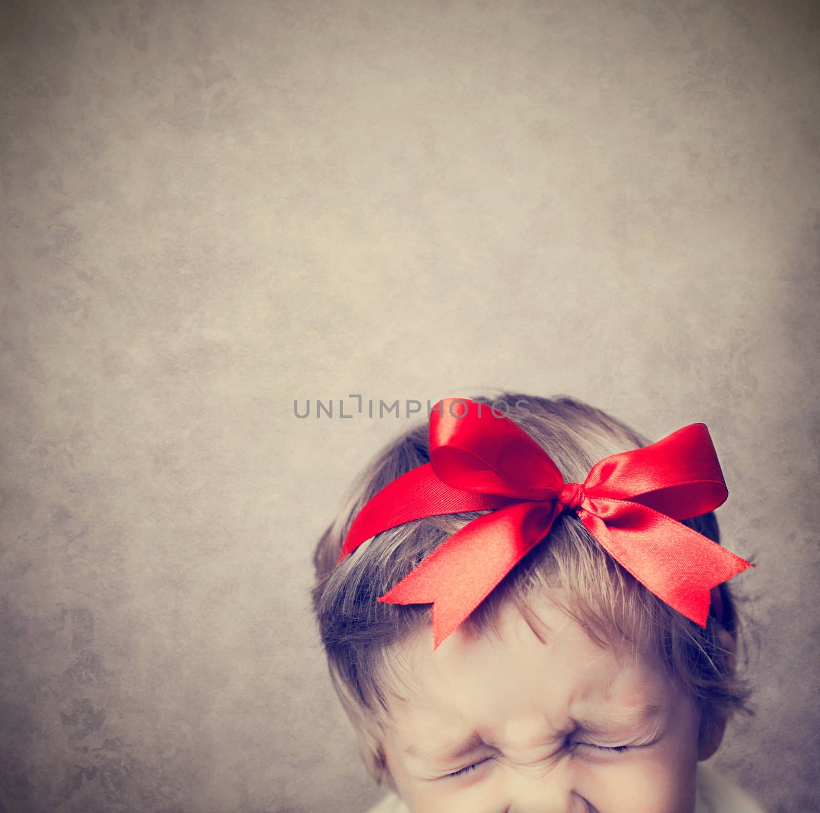 little boy with a red bow