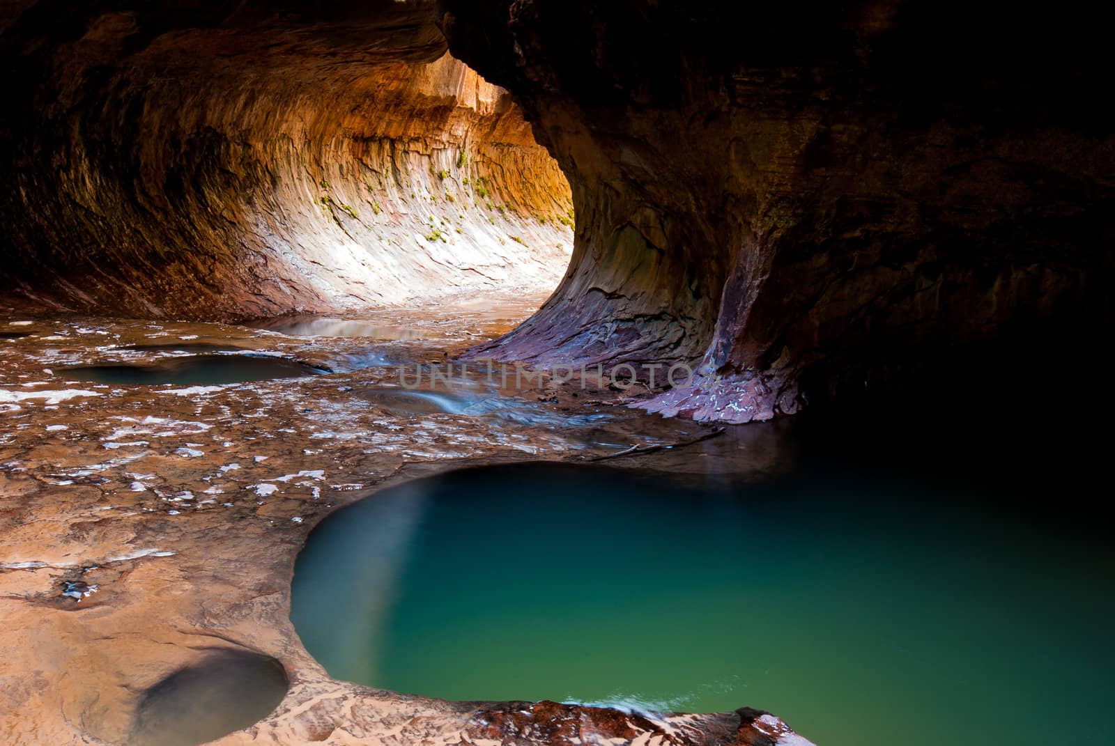 Photograph of the famous Subway Formation of Zion National Park with the Emerald Pools.  View looking towards the entrance.