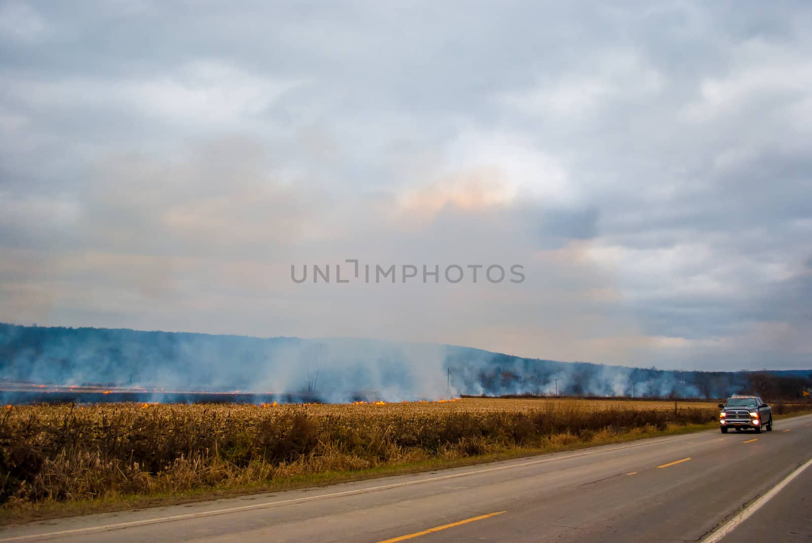 Photograph of a controlled agricultural burn set to clear a field after the crops had been harvested.