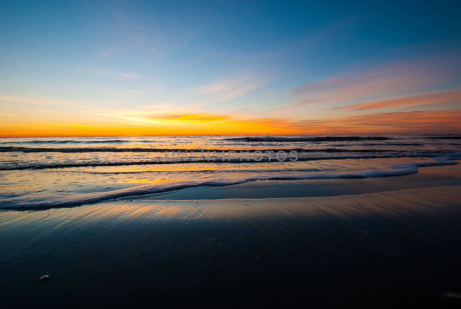 Photogrpah of a sunrise before the sun crests the horizon of a Saint Simons Island Beach.