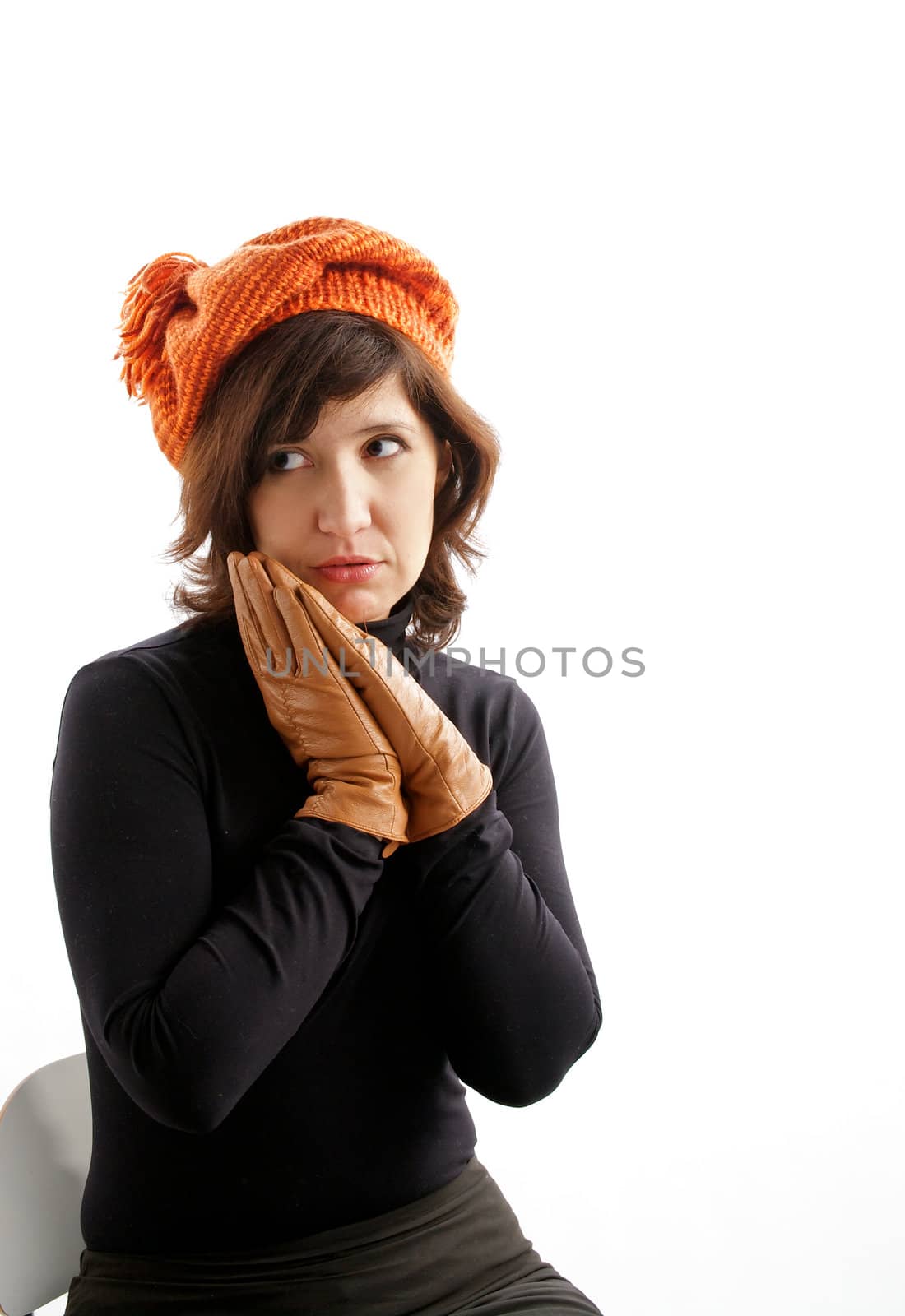 Young Attractive Woman Sitting in Knitting Hat and Gloves and Asks "Where is my Fur Coat?"