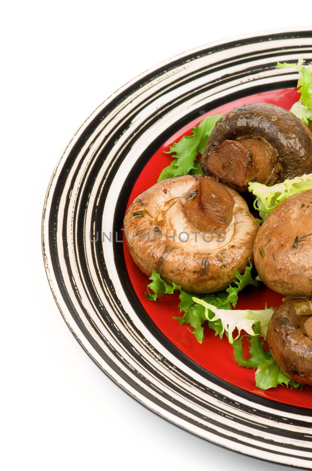 Roasted Champignon Mushrooms with Greens on Red Plate cross section isolated on white background