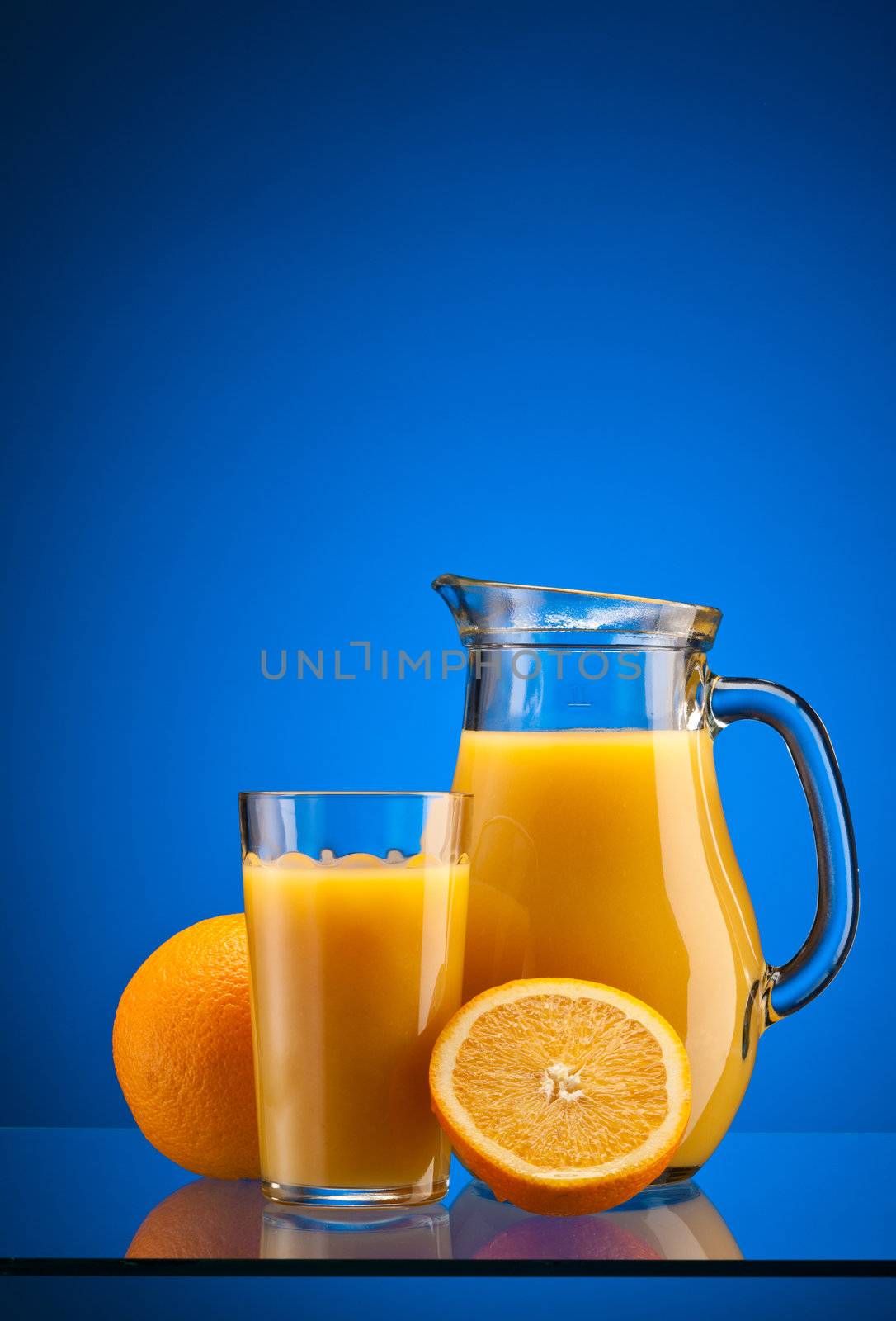 tasty orange juice over blue background