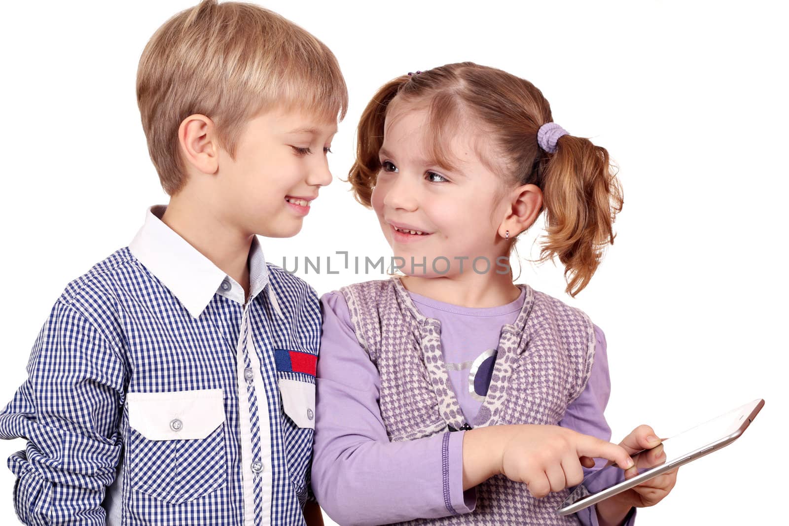 happy little girl and boy play with tablet pc