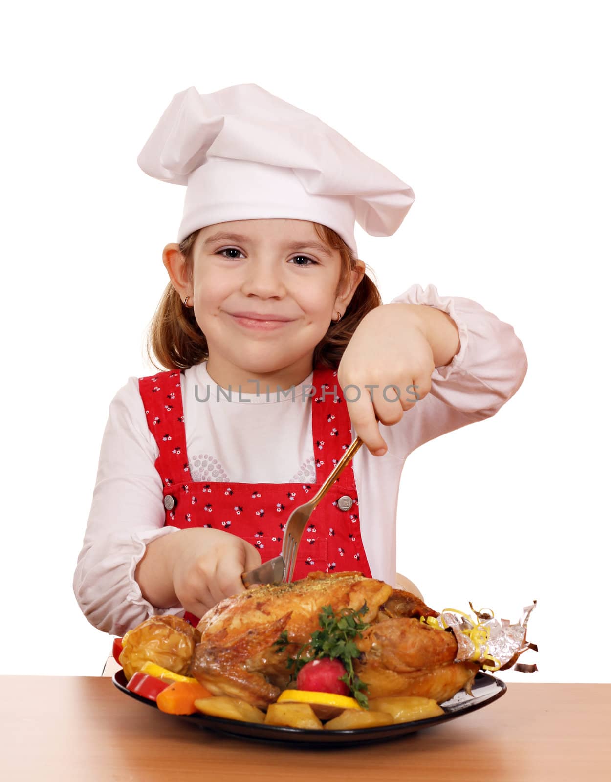 little girl cook cutting roast chicken by goce