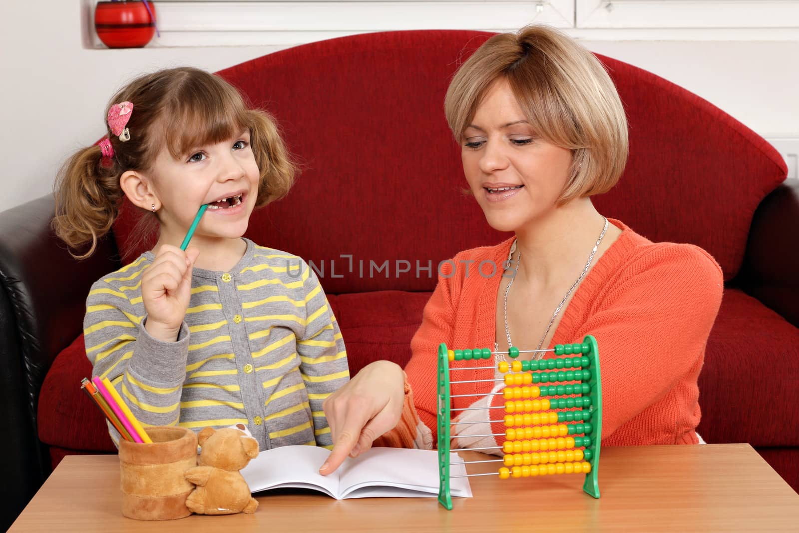 Mom helps daughter to solve homework