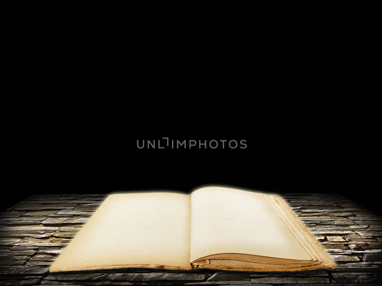 Old open book with blank pages on stone grunge background