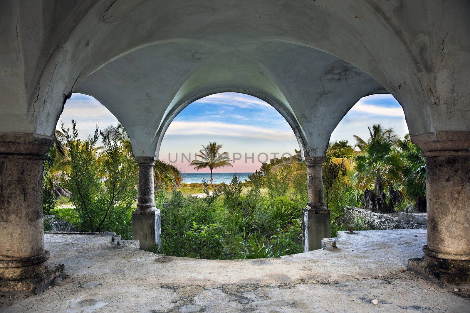 A beautiful view of the ocean from inside an old abandoned mansion.