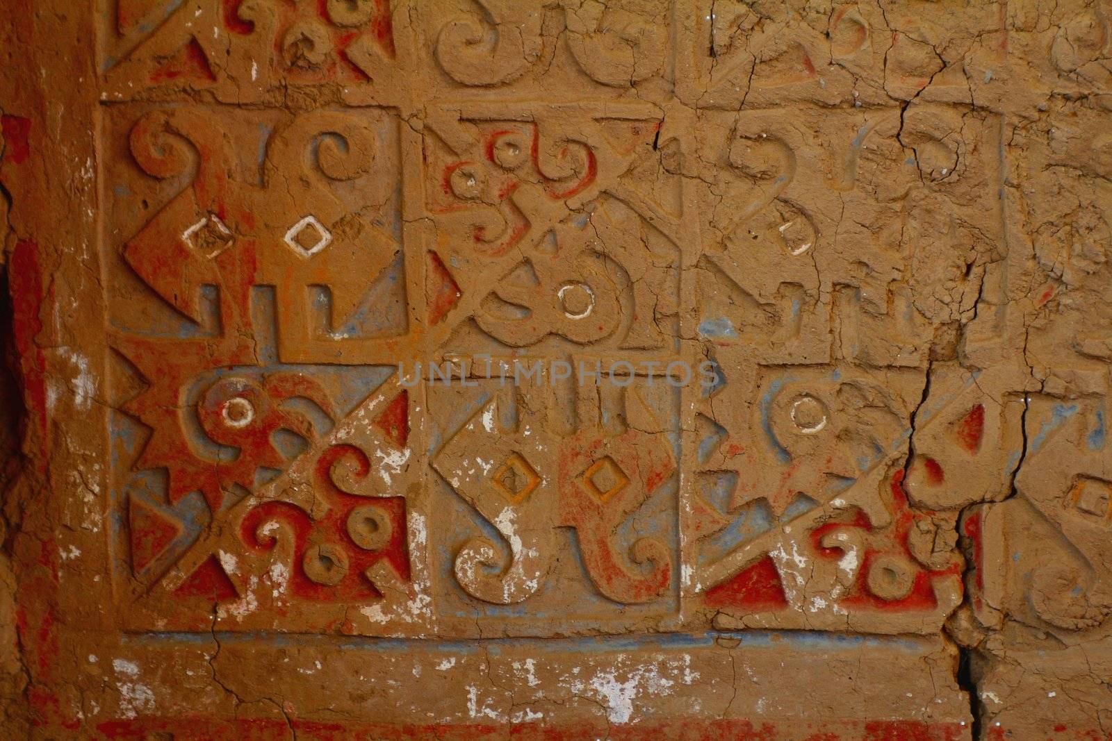 Painted and carved adobe wall in Huaca de la Luna, archaeological site in the Moche valley, Peru
