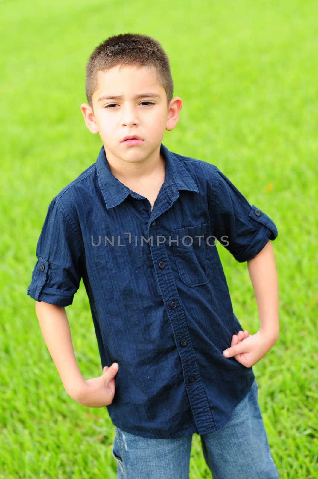 Young boy who is upset with a scowl