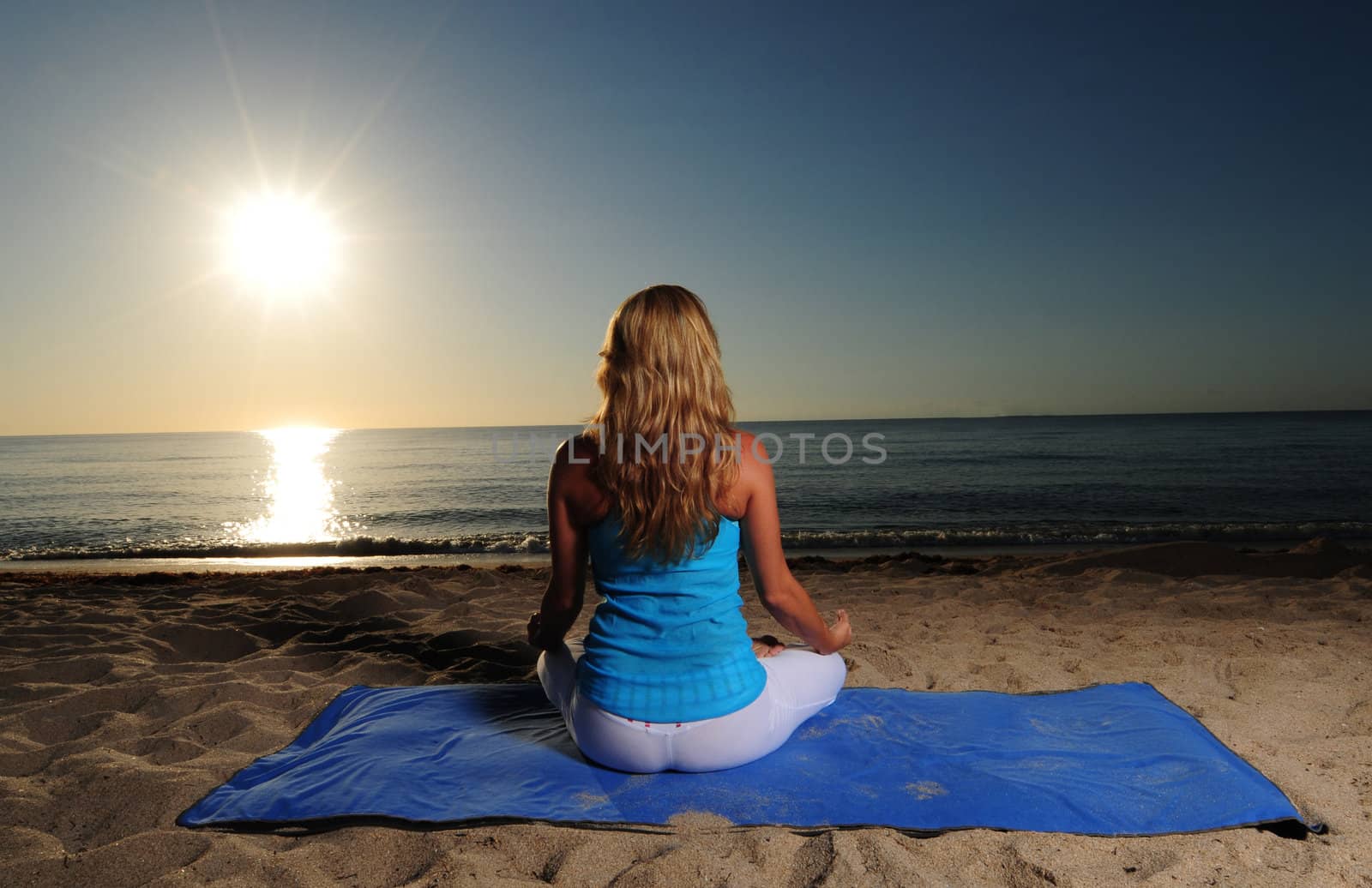 Meditation on beach with ocean and beautiful sunrise