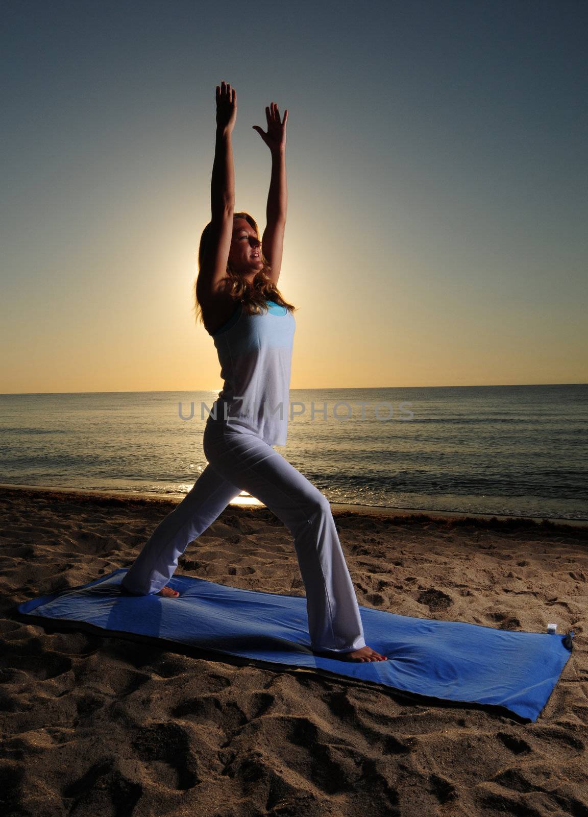 Woman doing yoga pose on beautiful beach