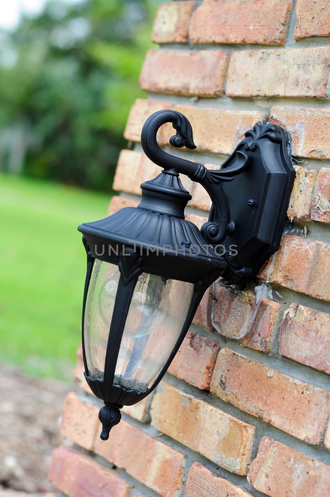 A light fixture on the exterior of a brick house