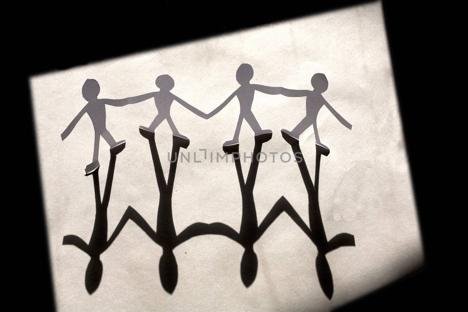 small rudimentary figures of man in paper