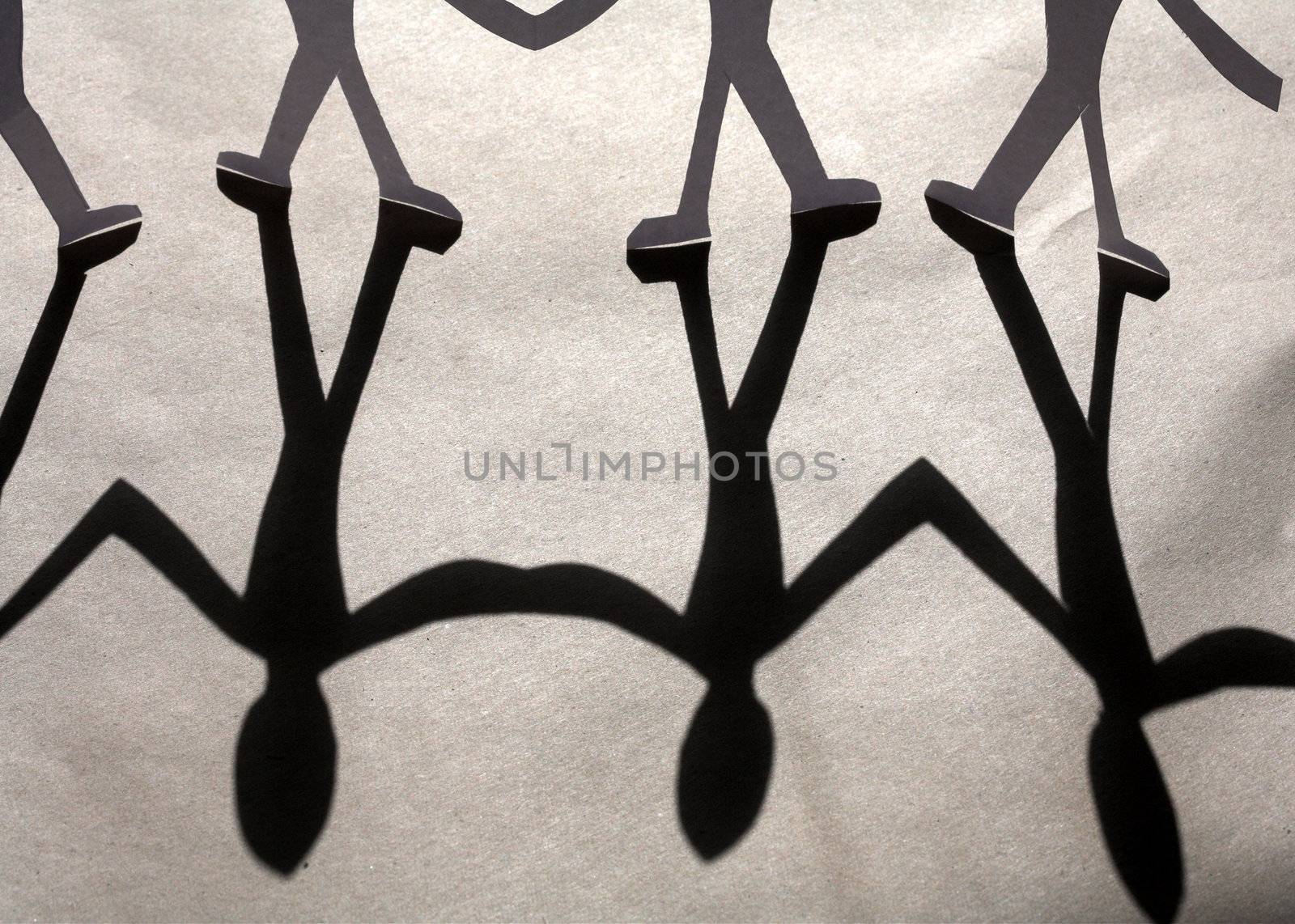 small rudimentary figures of man in paper