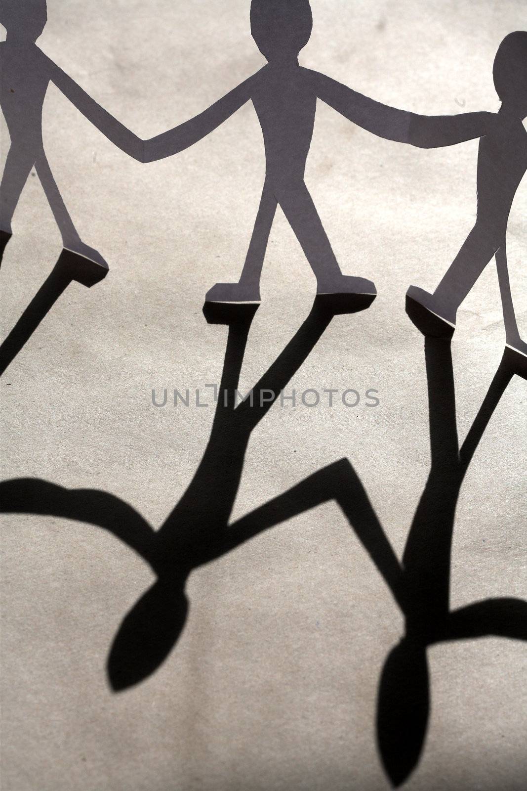 small rudimentary figures of man in paper