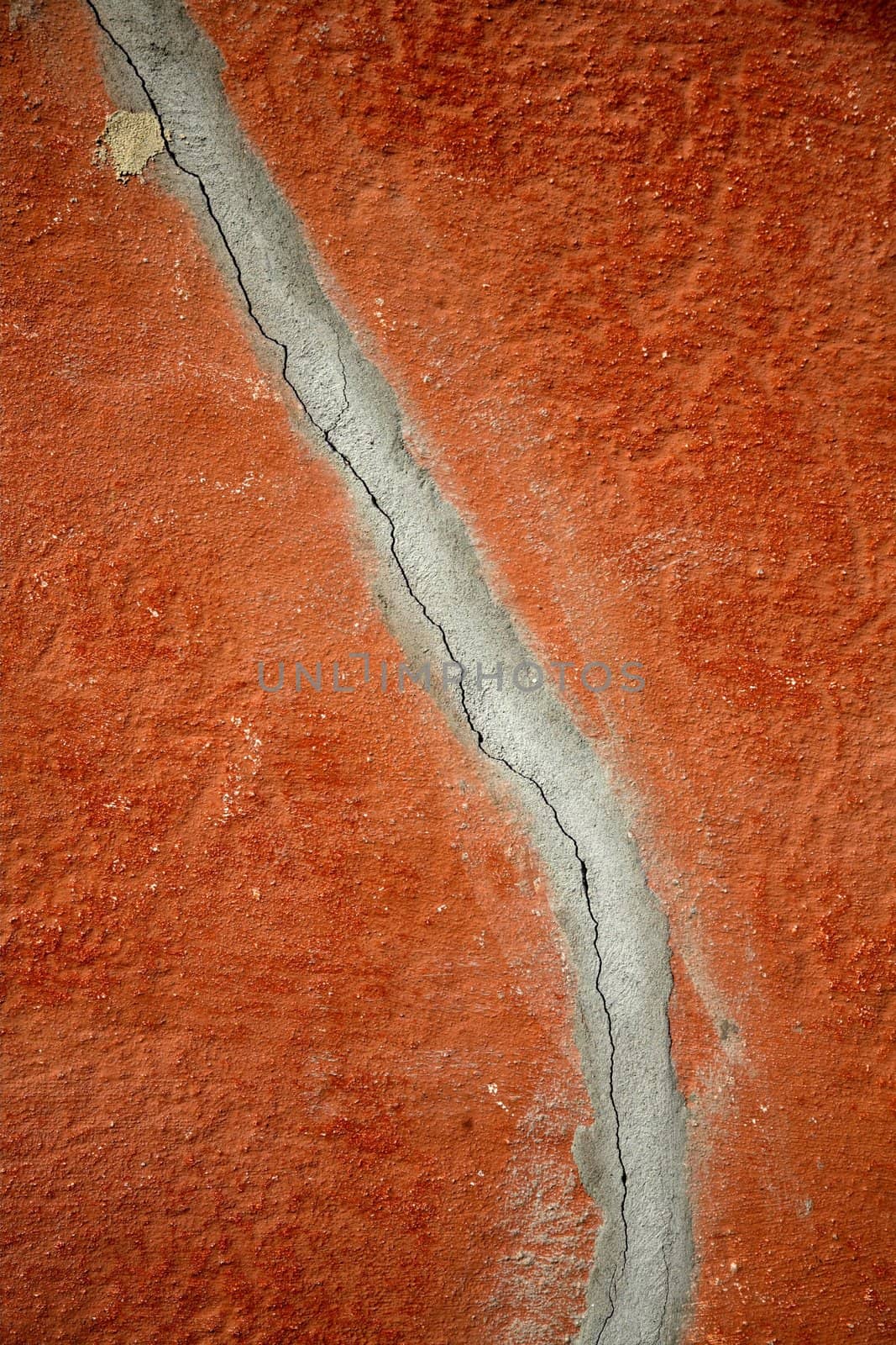 wall of a house red and cracked

