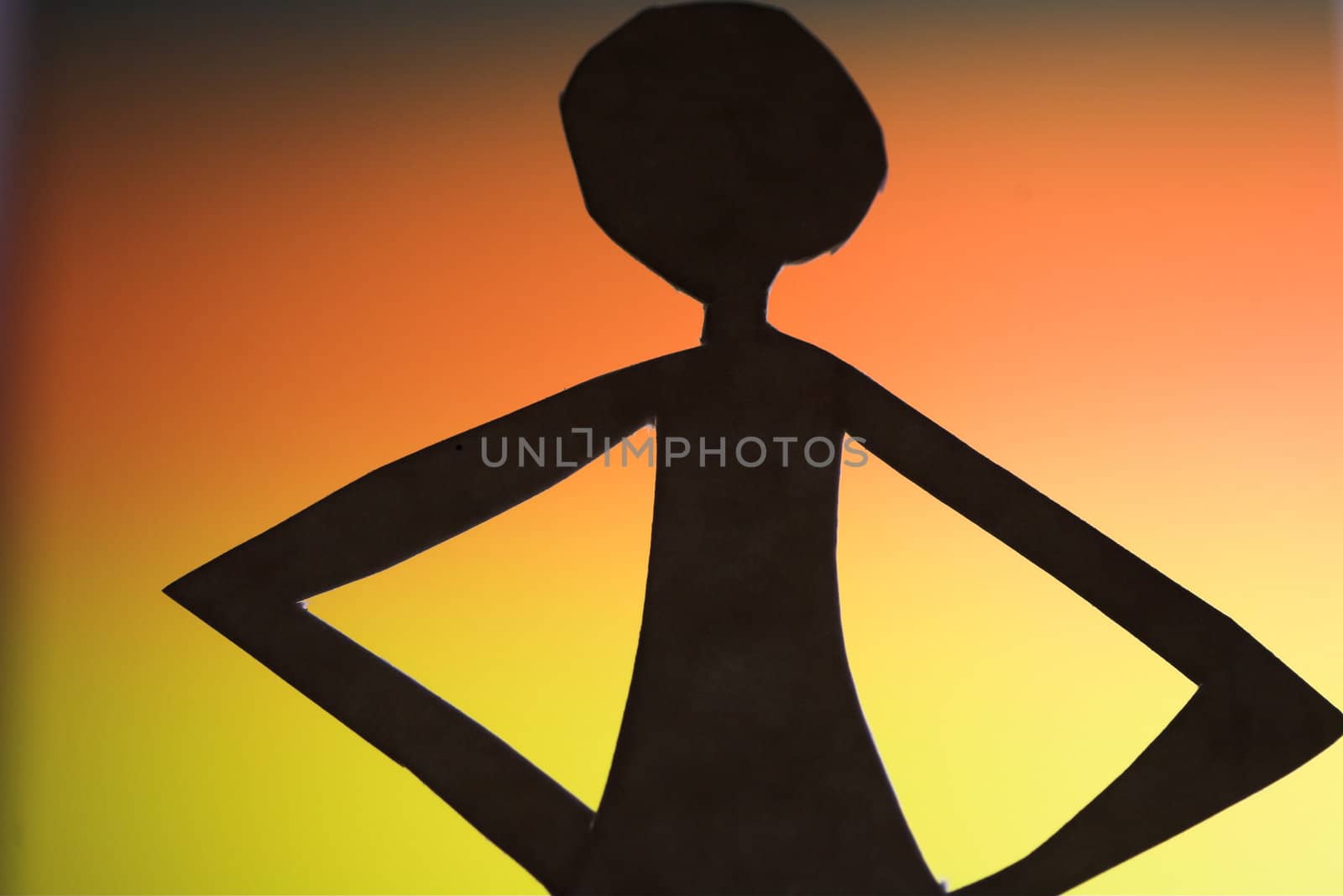 woman silhouette cut in small rudimentary figures  in paper , shot with colorfull background