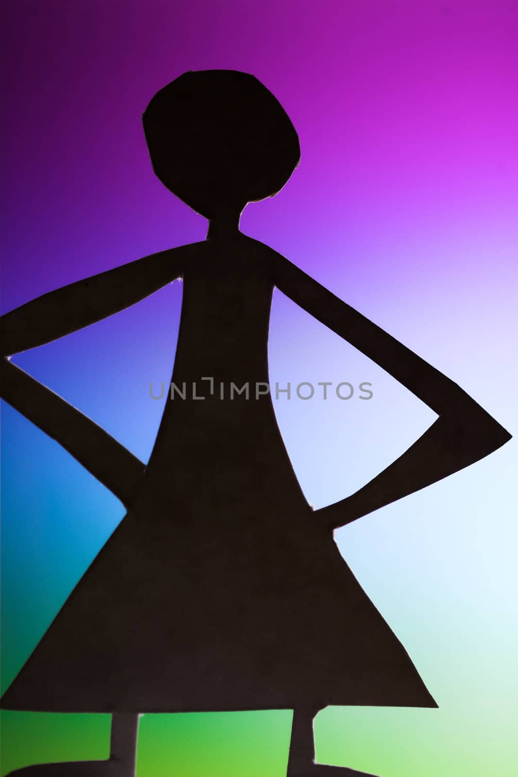 woman silhouette cut in small rudimentary figures  in paper , shot with colorfull background