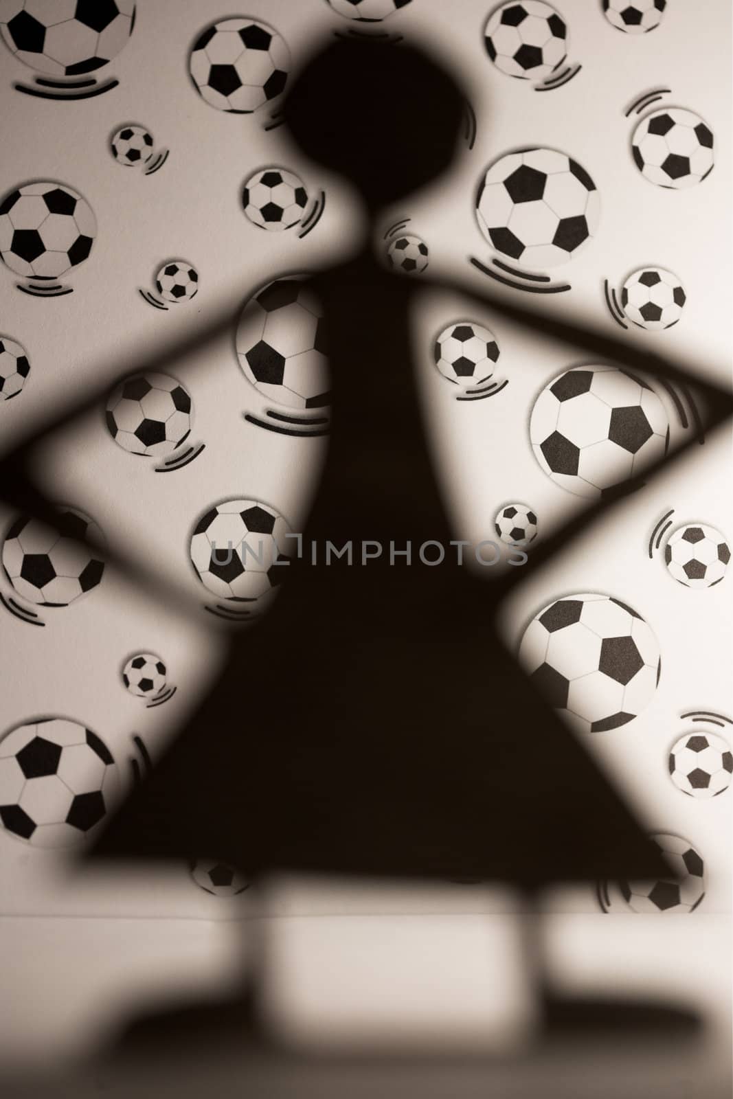 woman silhouette cut in small rudimentary figures  in paper , shot with colorfull background
