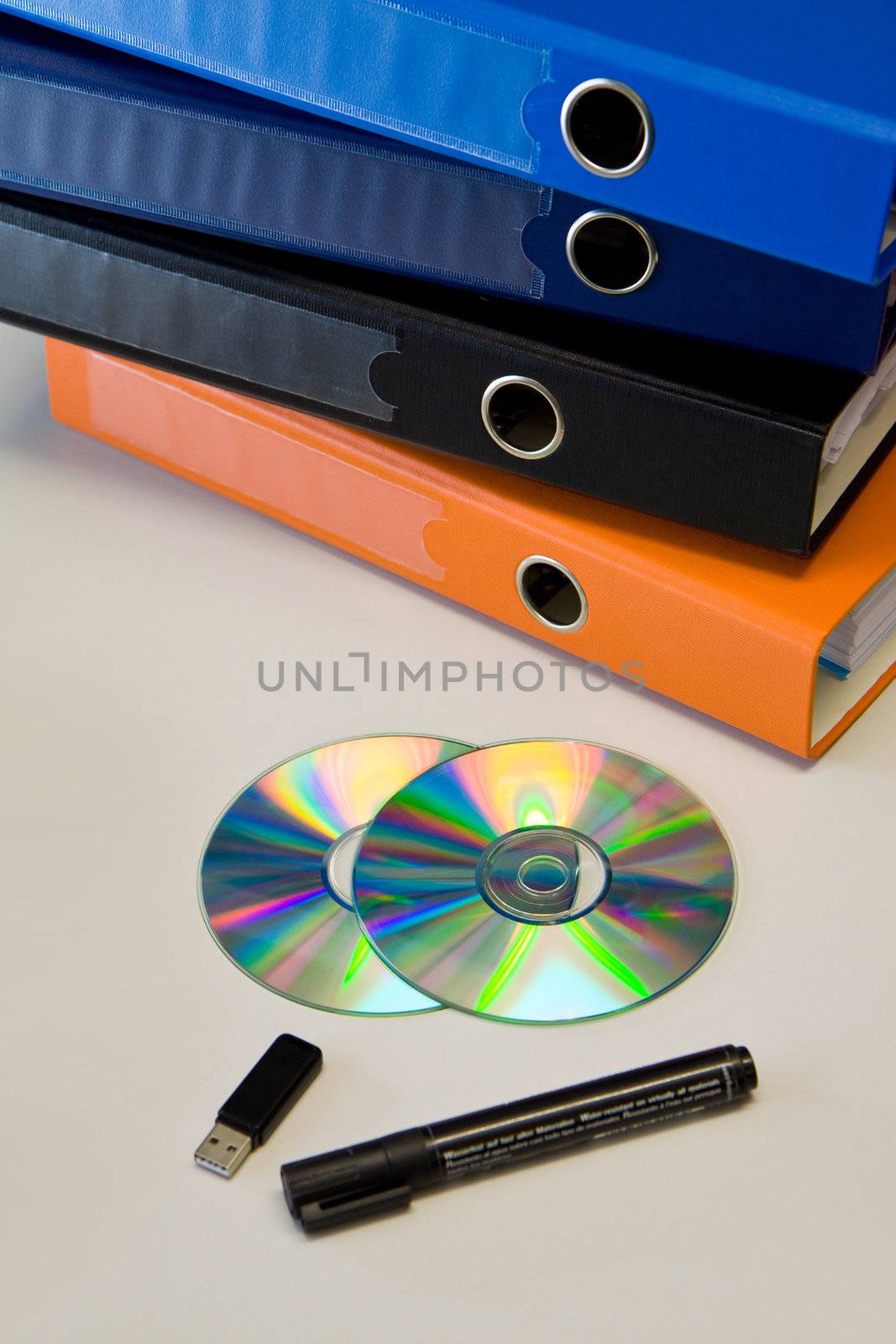 Color binders, and office stuff on bright table, workplace