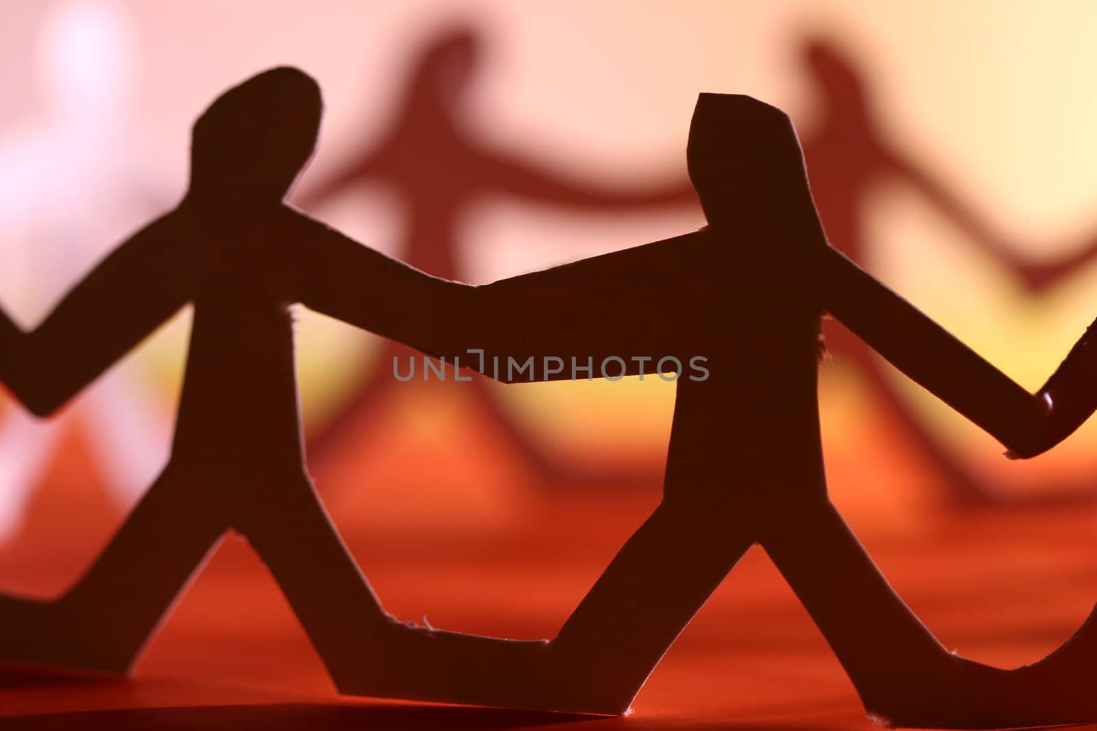small rudimentary figures of man in paper
