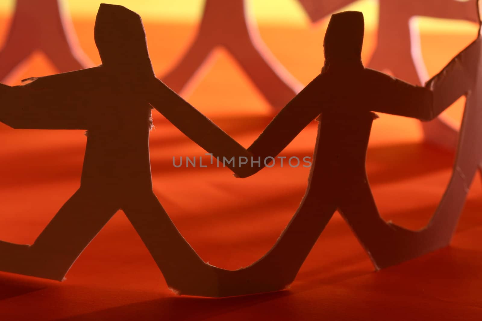 small rudimentary figures of man in paper